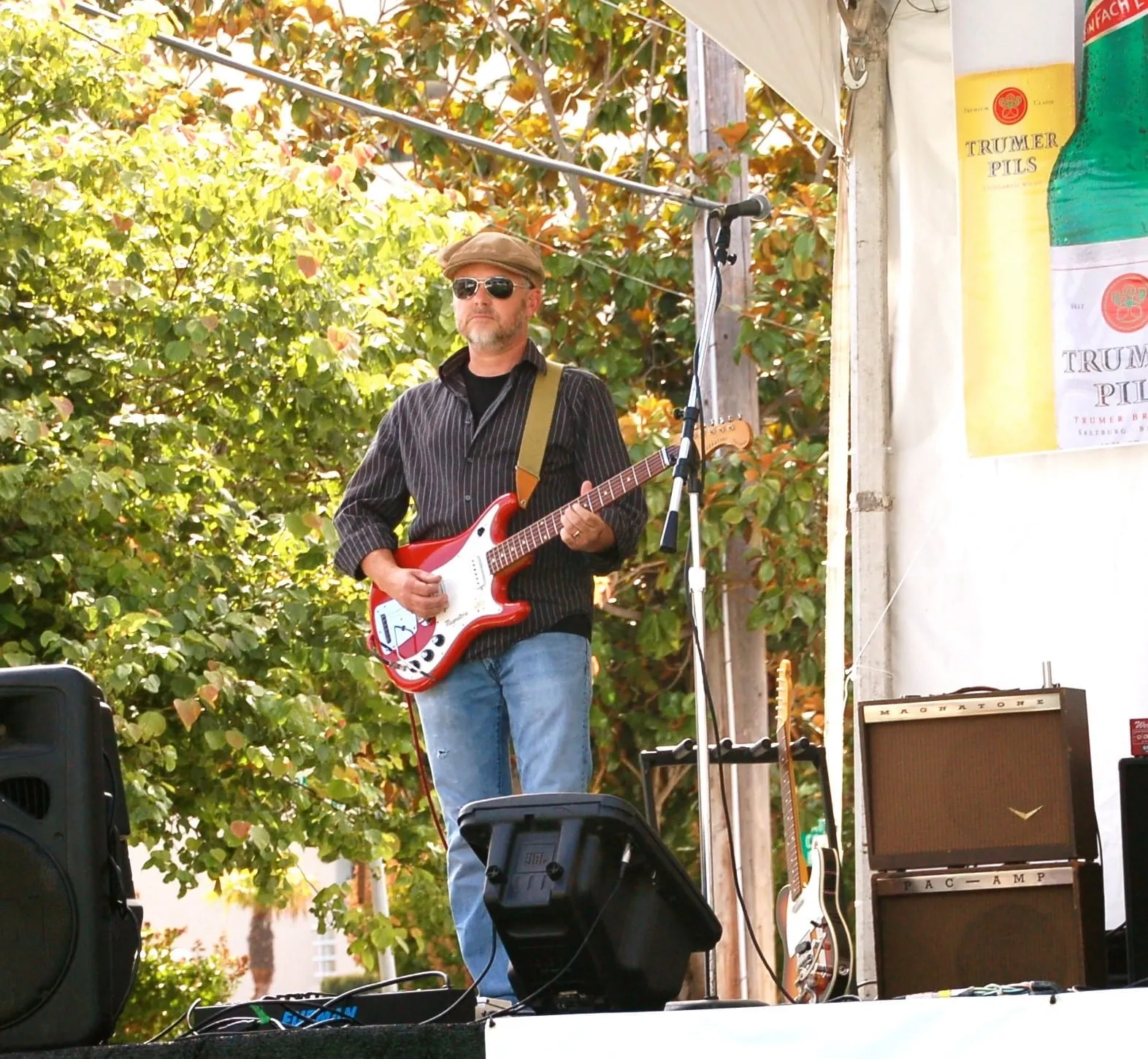 Red magnatone guitar at a festival